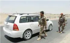  ??  ?? Afghan army soldiers search vehicles at a checkpoint on a highway leading to the Maiwind district of Kandahar.