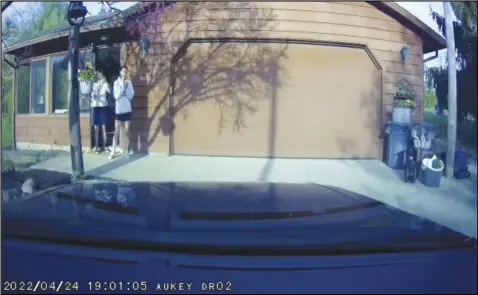  ?? ?? Dash cam still shot provided with the affidavit shows Anita Green and Amanda Hovenac outside the home