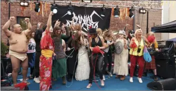  ?? AP PHOTO/DAVID KEYTON ?? The competitor­s of the first Heavy Metal Knitting world championsh­ip react on stage, on Thursday, in Joensuu, Finland.