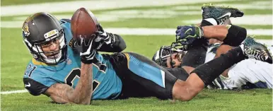  ??  ?? Jaguars cornerback A.J. Bouye intercepts a pass intended for Seahawks wide receiver Doug Baldwin during Jacksonvil­le’s home win. STEVE MITCHELL/USA TODAY SPORTS