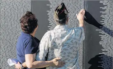  ?? Ricardo DeAratanha
Los Angeles Times ?? GARY MITCHELL, a Vietnam veteran, and his wife, Ellen, examine a traveling copy of the Vietnam Veterans Memorial. A researcher suggests that patients who don’t recover early on will have chronic PTSD.