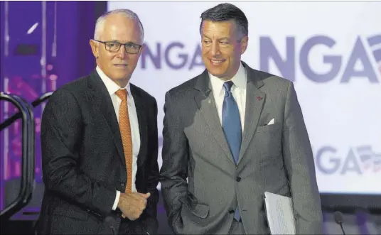  ?? Jose Luis Magana The Associated Press ?? Nevada Gov. Brian Sandoval, right, chairman of the National Governors Associatio­n, talks with Australian Prime Minister Malcolm Turnbull on Saturday in Washington.