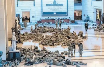  ?? J. SCOTT APPLEWHITE/AP ?? Hundreds of National Guard troops hold inside the Capitol Visitor’s Center to reinforce security Wednesday at the Capitol in Washington.