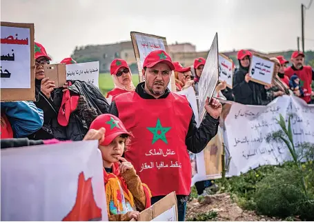  ?? AFP ?? A man wearing a vest showing the slogan, ‘Long live the king, down with the real estate mafia,’ joins a protest against a real estate group linked to the scandal.