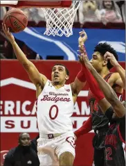  ?? ASSOCIATED PRESS ?? Wisconsin guard D’Mitrik Trice, a Wayne High School graduate, scores in the first half Saturday against Ohio State. Trice had 12 points and 8 assists in 38 minutes, but it wasn’t enough to beat the Buckeyes.