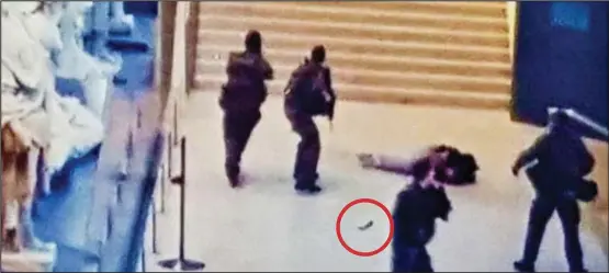  ??  ?? Shot: A photo posted online thought to show the knifeman on the ground surrounded by armed soliders and one of the machetes, circled