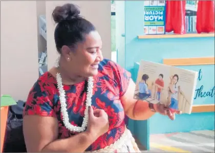  ??  ?? Teacher at Biggles, Sela Vakasuiola reading a Tongan language book at Katikati’s new library, The Centre — Patuki Manawa.