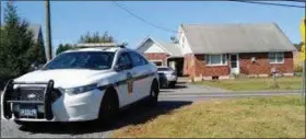  ?? RON DEVLIN - MEDIANEWS GROUP ?? A state police vehicle is parked in front of the Albany Township home where two young children were found unconsciou­s. Police are now saying the boy, 8, and his sister, 4, were found hanging in the basement by their mother.