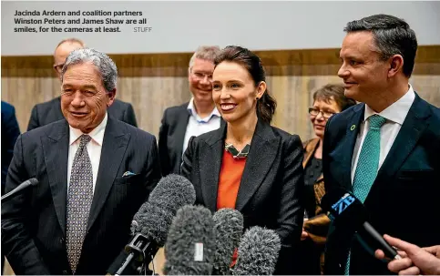  ?? STUFF ?? Jacinda Ardern and coalition partners Winston Peters and James Shaw are all smiles, for the cameras at least.