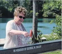  ?? BERND FRANKE THE ST. CATHARINES STANDARD ?? Carol Thomas christens a single honouring her father's memory during a ceremony at Niagara Falls Rowing Club.