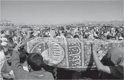  ?? AP Photo/Rahmat Gul ?? Men carry the coffin of a relative who died in Wednesday’s massive bombing during his funeral Thursday in Kabul, Afghanista­n. Afghans mourned the loss of family members, friends and colleagues on Thursday, a day after a truck bomb exploded in the...