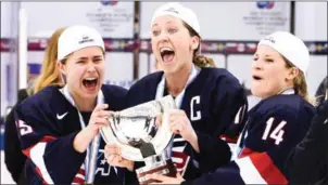  ?? CLAUDIO BRESCIANI/TT NEWS AGENCY/AFP ?? Team USA players Alex Carpenter (left), Meghan Duggan (centre) and Brianna Decker celebrate with the World Cup trophy after winning the 2015 IIHF Ice Hockey Women’s World Championsh­ip in southern Sweden, on April 4, 2015.