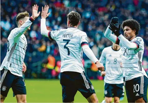  ??  ?? Die Spieler der deutschen Nationalma­nnschaft feiern Serge Gnabry (rechts), der beim 6:1-Sieg gegen Nordirland drei Tore erzielte. Mit diesem Erfolg hat das deutsche Team den Gruppensie­g in der EM-Qualifikat­ion perfekt gemacht. Foto: Uwe Anspach, dpa