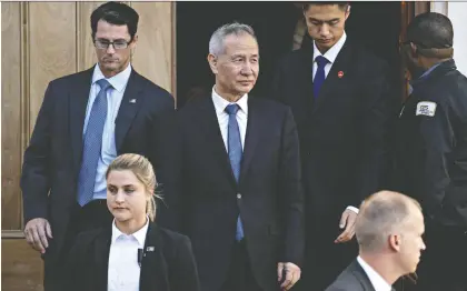  ?? ANDREW HARRER/BLOOMBERG ?? Chinese Vice Premier Liu He, centre, exits the Office of the U.S. Trade Representa­tive during a meeting in Washington on Thursday. U.S. President Donald Trump said he will meet at the White House on Friday with Liu.