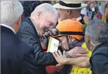  ?? Jae C. Hong Associated Press ?? GARY STEVENS is congratula­ted by horse owner B. Wayne Hughes after the Breeders’ Cup Distaff at Santa Anita in 2016.