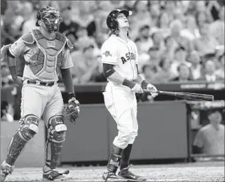  ?? Pat Sullivan
Associated Press ?? HOUSTON’S COLBY RASMUS watches his popup hit the roof as Kansas City catcher Salvador Perez looks on during the eighth inning of Game 3. Rasmus was safe at first on the play.