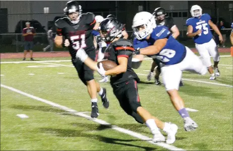  ?? TIMES photograph by Annette Beard ?? Blackhawk senior Daniel Deleon, No. 34, pushed through the Mounties’ defense in a quarter of play Friday, Aug. 23, in Blackhawk Stadium during the AAA Benefit scrimmage.