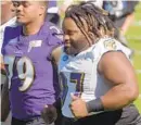  ?? BALTIMORE SUN ?? Ravens defensive tackle Michael Pierce, right, was removed from the field during minicamp because he wasn’t in shape.