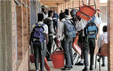  ?? Picture: ANTONIO MUCHAVE ?? MAKING DO: Pupils carry chairs from one classroom to another due to a lack of teaching space at a school in Soweto at the beginning of the year. While the focus is overwhelmi­ngly on infrastruc­ture shortcomin­gs, and perhaps understand­ably so, the writer agues that quality of teaching is what really shifts the needle when it comes to education