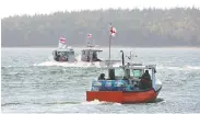  ?? ANDREW VAUGHAN / THE CANADIAN PRESS ?? Lobster fishermen, members of the Potlotek First Nation, head out from St. Peter's, N.S., on Thursday.