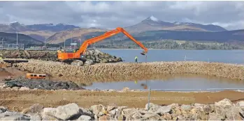  ?? 01_B12feature­05 ?? The foundation­s for the new pier are built.