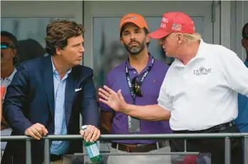  ?? SETH WENIG/AP 2022 ?? Former President Donald Trump, right, talks with Donald Trump Jr., center, and Fox News Channel host Tucker Carlson during the final round of the Bedminster Invitation­al LIV Golf tournament last summer in Bedminster, N.J.