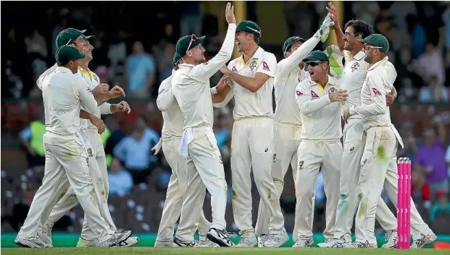  ?? GETTY IMAGES ?? Australia’s players celebrate the fall of another England wicket in what has been a familiar scene during the five-match Ashes test series dominated by the men wearing the baggy green caps.