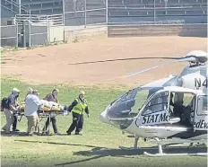  ?? ?? Rushdie is taken on a stretcher to a helicopter after he was attacked