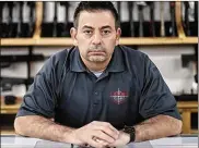  ?? JOSHUA A. BICKEL / COLUMBUS DISPATCH ?? Eric Deibert, co-owner of L.E.P.D. Firearms, Range and Training Facility stands inside his store on Tuesday in Columbus.