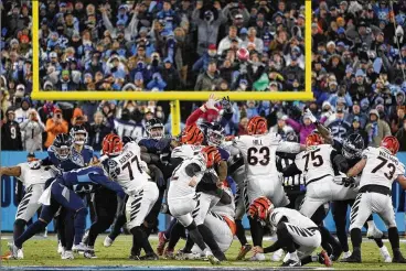  ?? MARK HUMPHREY / AP ?? Bengals kicker Evan McPherson kicks a 52-yard field goal as time expires to lift Cincinnati past the Tennessee Titans, 19-16, and into a berth in the AFC Championsh­ip game Sunday. McPherson is 8-for-8 in the playoffs.