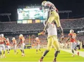  ?? JIM RASSOL/STAFF FILE PHOTO ?? Florida State offensive tackle Cameron Erving and running back James Wilder Jr. celebrate a touchdown vs. UM last season.