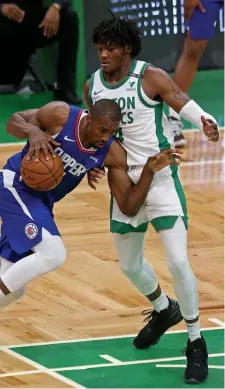  ??  ?? STANDING TALL: Robert Williams, right, defends Clippers big man Serge Ibaka.