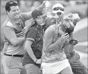  ?? AP/STEVE HELBER ?? Lexi Thompson (front) celebrates after winning the Kingsmill Championsh­ip on Sunday in Williamsbu­rg, Va. Thompson led the tournament from start to finish.