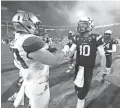  ??  ?? ASU QB Taylor Kelly greets Arizona linebacker Jake Fischer on Nov. 30, 2013.