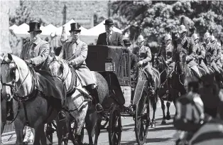  ?? AP PHOTO BY FRANK AUGSTEIN ?? A carriage is driven Thursday through the streets of Windsor, England, during a rehearsal for the procession of the upcoming wedding of Britain’s Prince Harry and Meghan Markle.