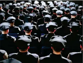  ?? DREW ANGERER/GETTY IMAGES NORTH AMERICA/AFP ?? The newest members of the New York City Police Department attend their police academy graduation ceremony at the Theater at Madison Square Garden, March 30, in New York City.