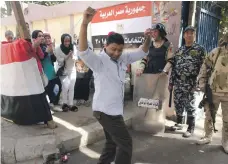  ?? AP ?? Good spirits prevail at polling stations in Cairo but many polling officials said voting was slow yesterday