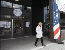  ?? PHOTO BY PAUL CONNORS — MEDIA NEWS GROUP/BOSTON HERALD ?? Eileen Regan walks out of the Roche Community Center after casting a ballot in West Roxbury Saturday.