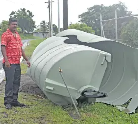  ?? Photo: Waisea Nasokia ?? Avinesh Kumar, with a damaged water tank along the roadside in Field 40 in Lautoka on February 6, 2018.