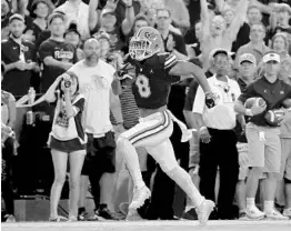  ?? SAM GREENWOOD/GETTY IMAGES ?? Florida wide receiver Trevon Grimes scored on his first touch for the season for the Gators, a first-quarter screen he took to the end zone against Charleston Southern.