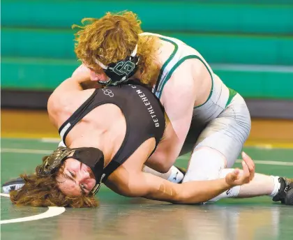  ?? RICK KINTZEL ?? In the 138-pound weight class, Bethlehem Catholic’s Matt Mayer, bottom, battles Central Dauphin’s Josh Miller Wednesday during a PIAA team wrestling, Class 3A quarterfin­al at Central Dauphin High School with Mayer losing 5-2.