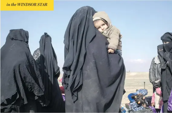  ?? CHRIS MCGRATH / GETTY IMAGES ?? Civilians who have fled fighting in Baghouz, the last village held by ISIL, wait to board trucks on Saturday after being screened by members of the Syrian Democratic Forces.