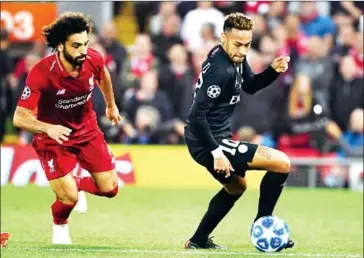  ?? PAUL ELLIS/AFP ?? Mohamed Salah (left) vies with Paris Saint-Germain’s Brazilian striker Neymar during the Champions League match between Liverpool and Paris Saint-Germain at Anfield.