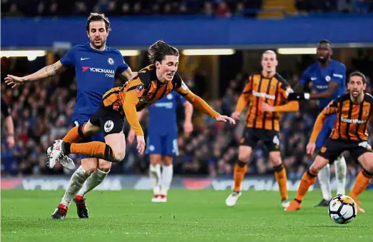  ??  ?? Getting rough: Chelsea’s Cesc Fabregas (left) in action against Hull’s Harry Wilson during the English FA Cup fifth round at Stamford Bridge on Friday. — Reuters