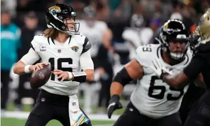  ?? Photograph: Gerald Herbert/AP ?? Jacksonvil­le Jaguars quarterbac­k Trevor Lawrence looks for a receiver during Thursday’s win against the New Orleans Saints.