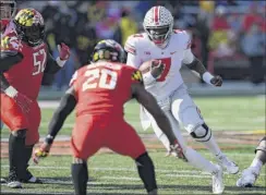  ?? Nick Wass / Associated Press ?? Ohio State’s Dwayne Haskins Jr. runs at Maryland’s Antwaine Richardson in the Buckeyes’ 52-51 overtime road victory.