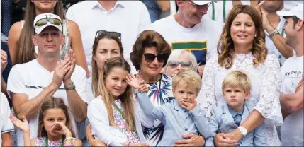  ??  ?? Federer's twins and wife cheering the Swiss Master to his 8th Wimbledon