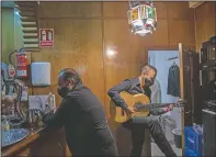  ??  ?? Flamenco guitarist Jose Sison tunes his guitar next to flamenco singer Antonio ‘El Pola’ rehearsing before taking part in a flamenco show at the Torres Bermejas.