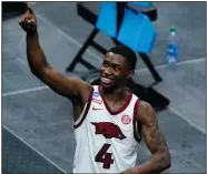  ?? (AP/Jeff Roberson) ?? Arkansas guard Davonte Davis points to the crowd Saturday after the Razorbacks beat the Oral Roberts Golden Eagles 72-70 in Indianapol­is. Davis’ 8-foot jumper with 3.1 seconds left gave Arkansas the victory.