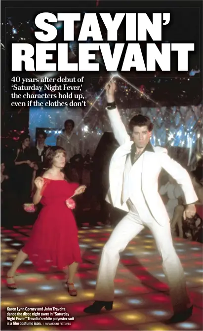 ??  ?? Karen Lynn Gorney and John Travolta dance the disco night away in “Saturday Night Fever.” Travolta’s white polyester suit is a film costume icon.| PARAMOUNT PICTURES